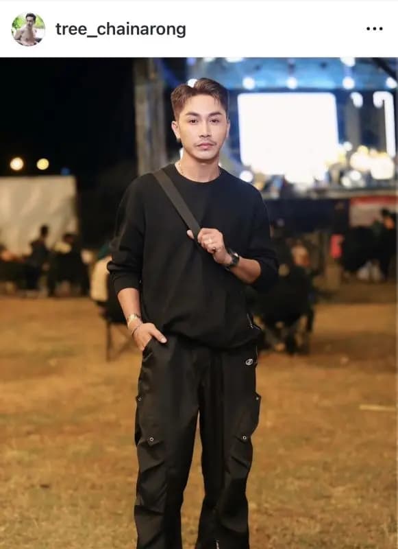 Tree Chainarong performing on stage surrounded by supportive fans