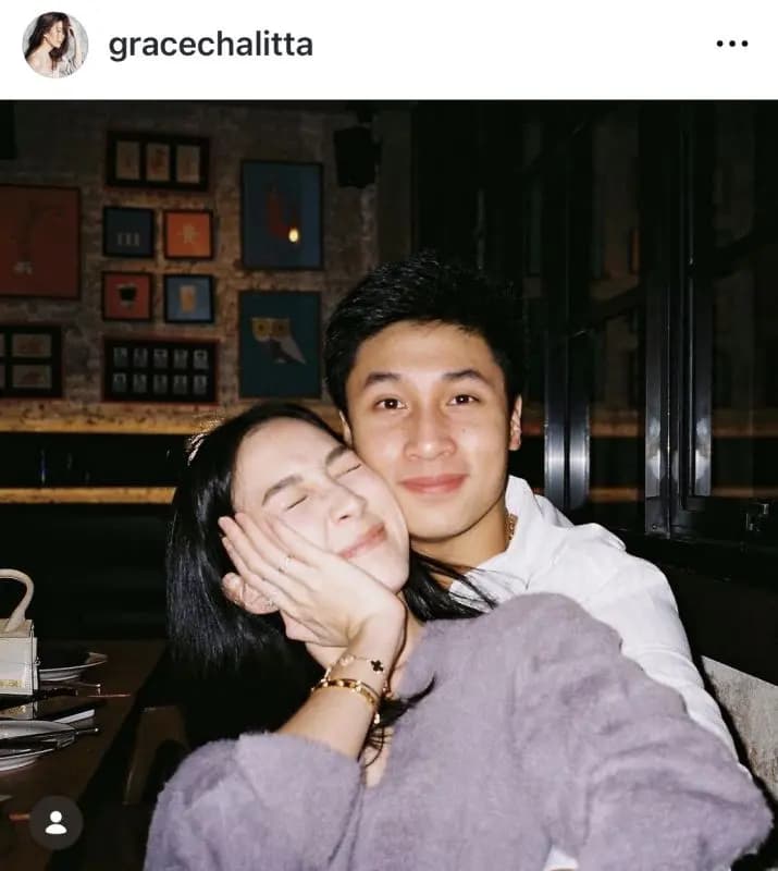 Grace Chonlita and Art Sasomsub posing together in a snowy romantic setting during their engagement